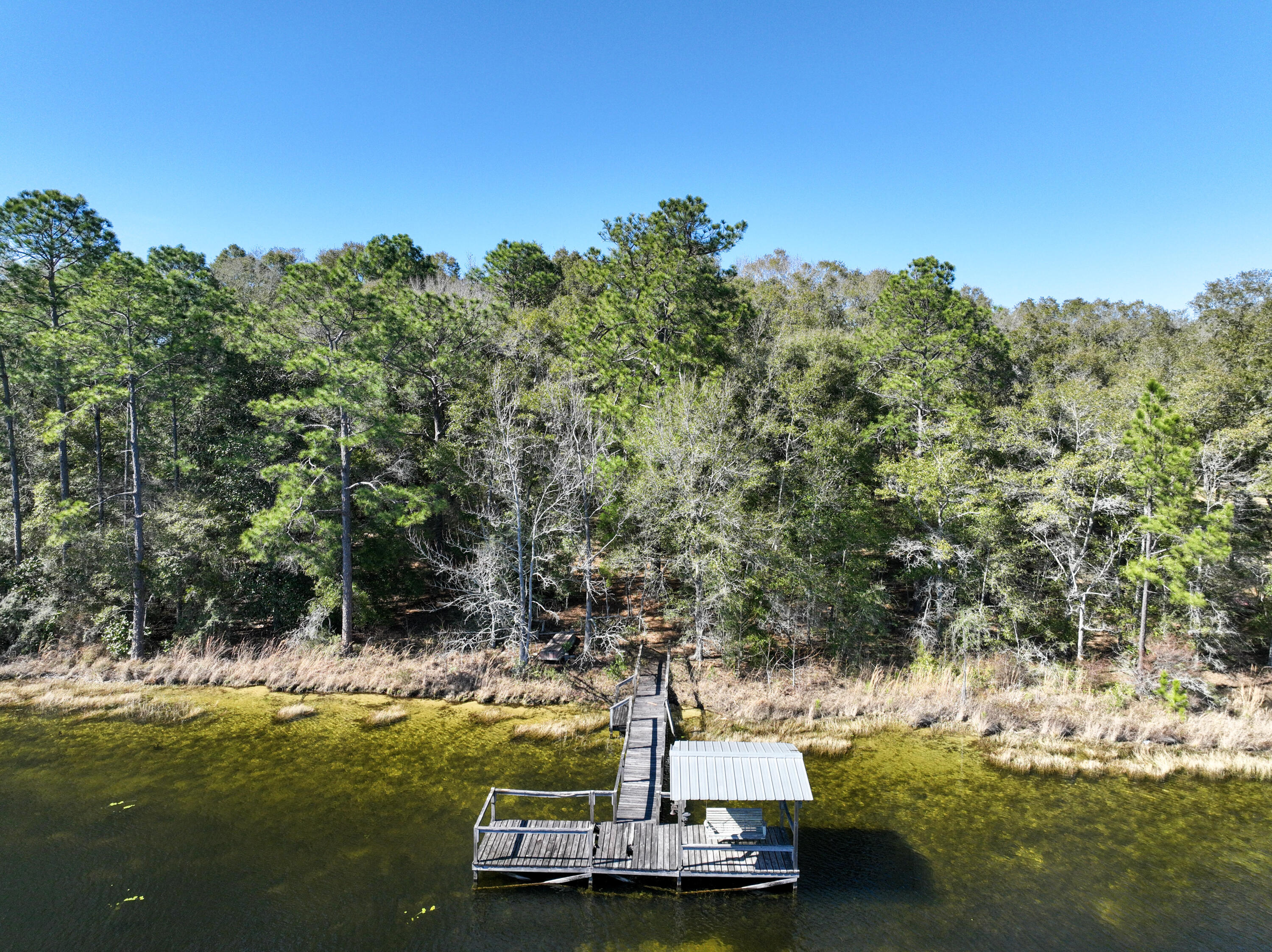299 Holley King Road DeFuniak Springs, FL 32433 - Photo 4 of 40 a view of a lake with houses