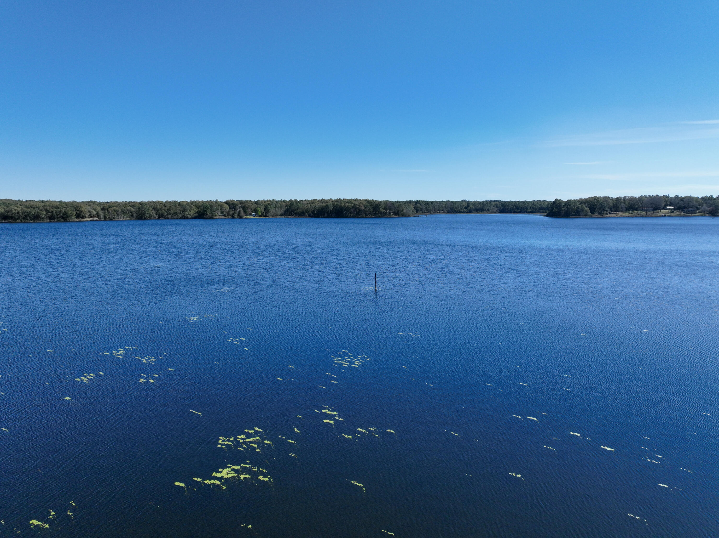 299 Holley King Road DeFuniak Springs, FL 32433 - Photo 5 of 40 a view of a lake and an ocean