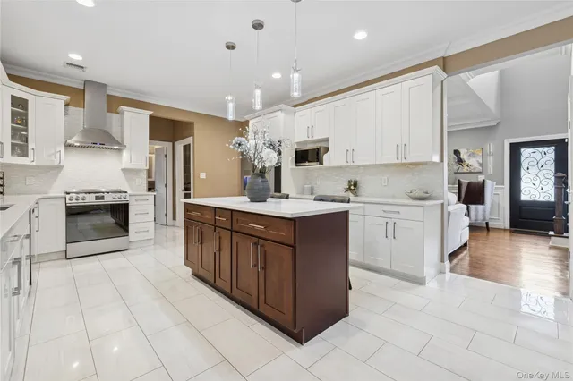 a kitchen with kitchen island granite countertop a sink counter top space appliances and cabinets