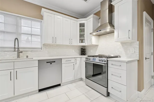 a kitchen with white cabinets and white appliances