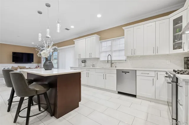 a kitchen with stainless steel appliances sink refrigerator and microwave