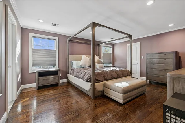 a view of a hallway with wooden floor and windows