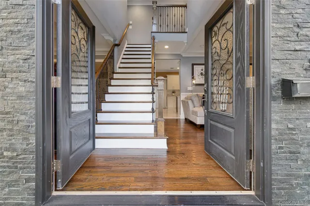 a view of entryway and hall with wooden floor