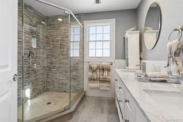 a bathroom with a double vanity sink and a mirror