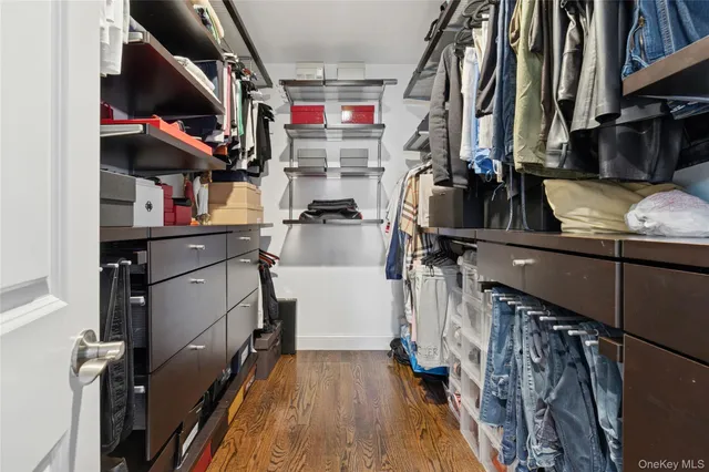 a bathroom with a granite countertop sink a mirror and shower