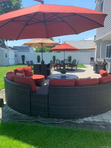 a view of a house with a yard and sitting area