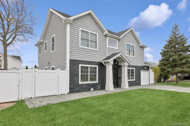 a view of a house with a yard and garage