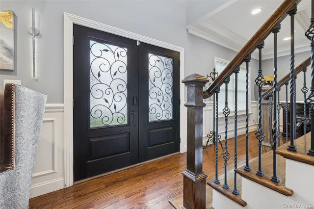 a view of an entryway with wooden floor