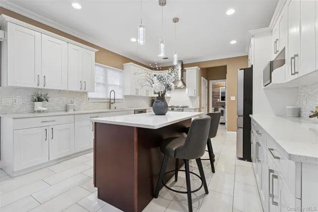 a kitchen with a sink refrigerator and cabinets