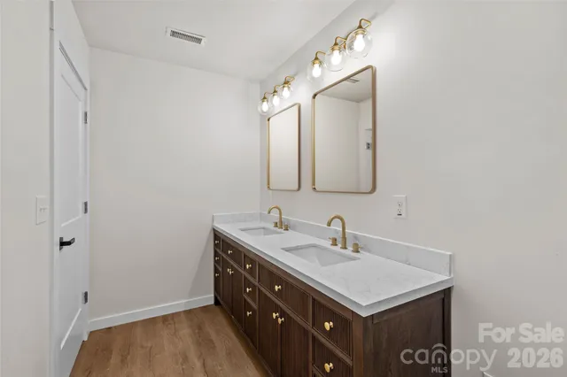 a bathroom with a sink vanity and a mirror