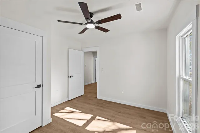 a view of a livingroom with a ceiling fan and window