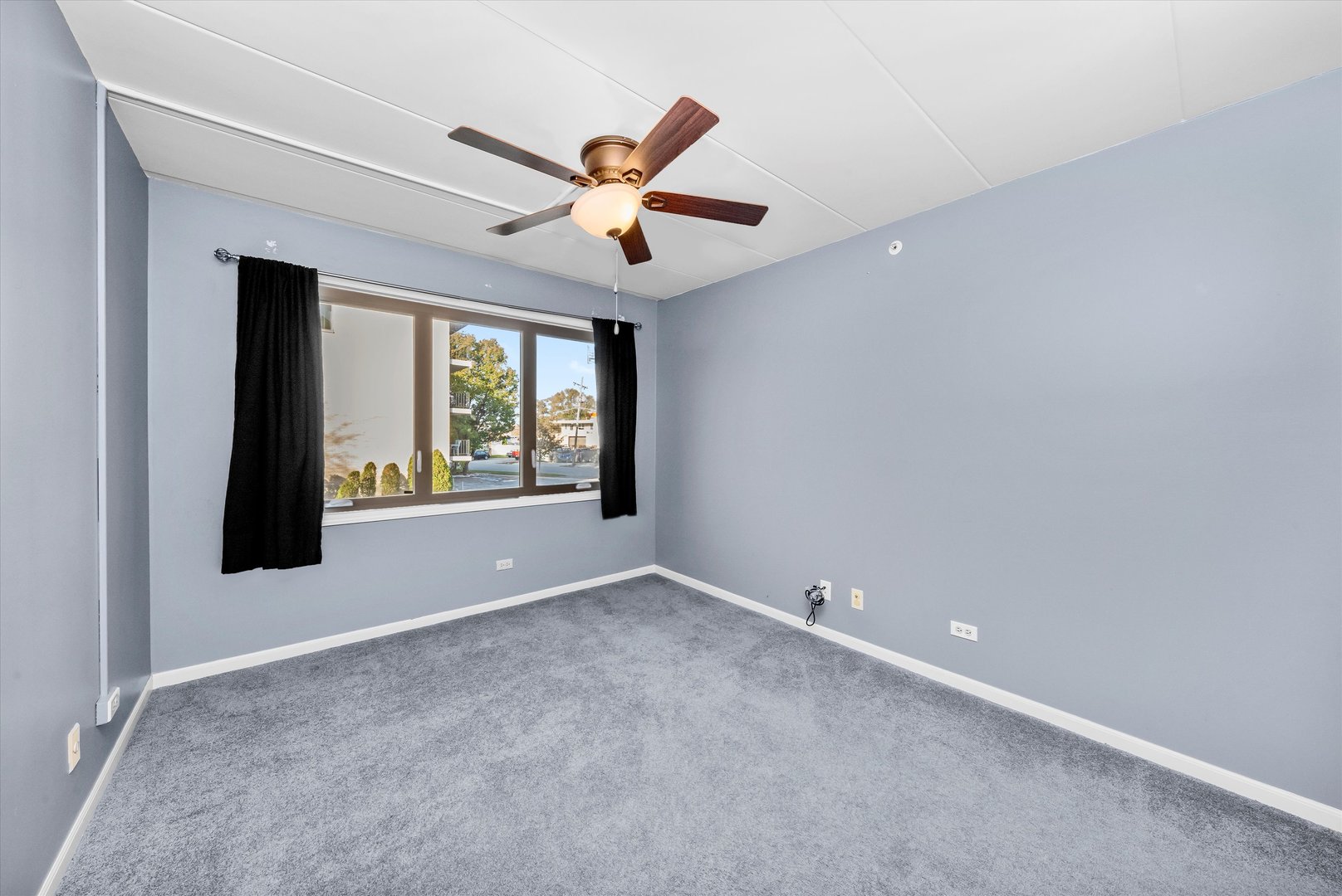 4530 West 93rd Street, Unit 1A Oak Lawn, IL 60453 - Photo 12 of 18 an empty room with windows and fan