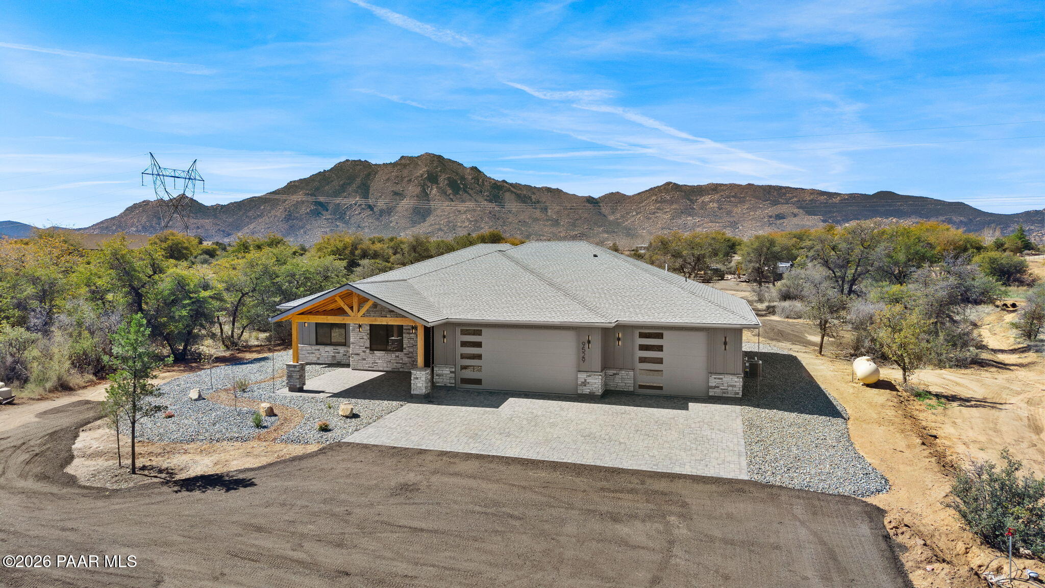 9529 North Bridle Ridge Road Prescott, AZ 86305 - Photo 7 of 43 a front view of a house with a yard and mountain view