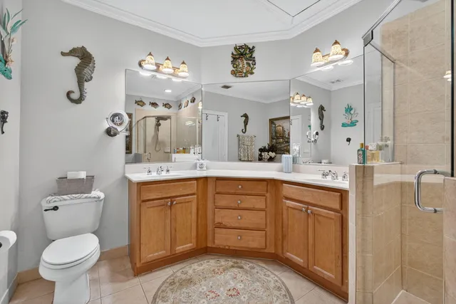 a spacious bathroom with a toilet sink and mirror
