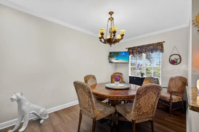 a view of a dining room with furniture and chandelier