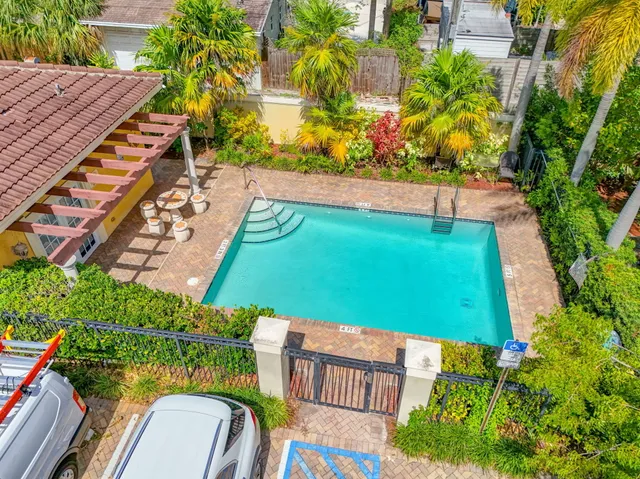 a view of a backyard with plants and outdoor seating