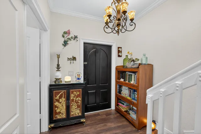 a view of a hallway with entryway wooden floor and front door