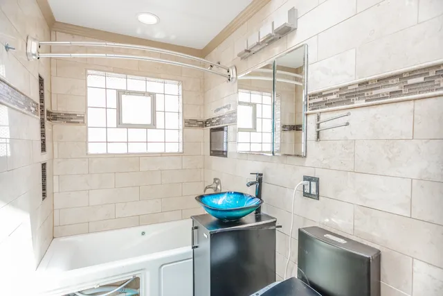 a bathroom with a sink toilet and tub