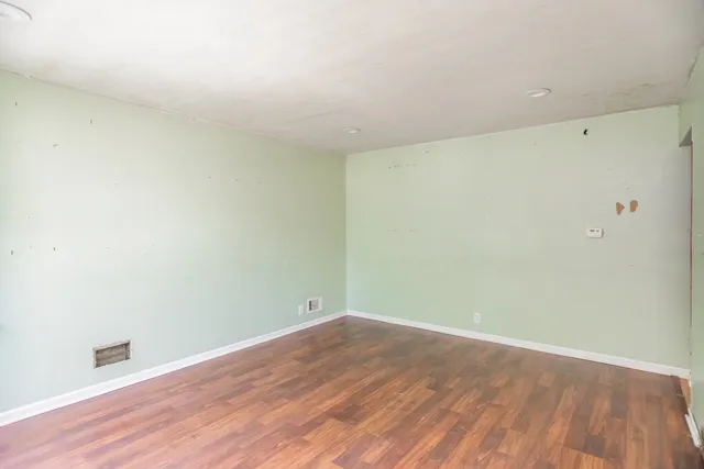 an empty room with wooden floor
