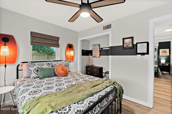a bedroom with a bed and a window