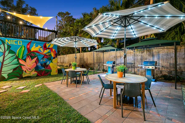 a view of a table and chairs under an umbrella