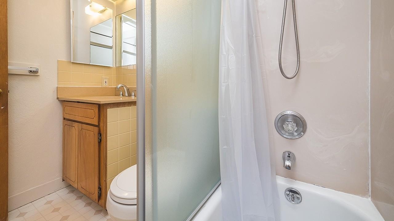 514 Baden Avenue South San Francisco, CA 94080 - Photo 25 of 25 a bathroom with a granite countertop shower a toilet and a sink