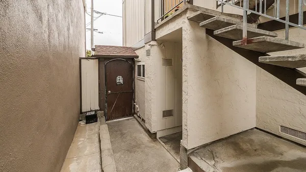 a view of a house with entryway and wooden floor