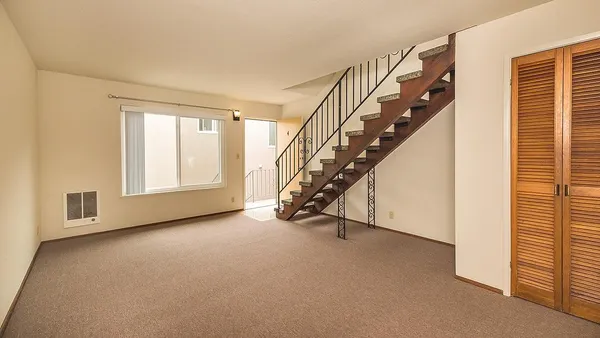 a view of an empty room with stairs