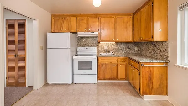 a kitchen with a refrigerator sink and cabinets