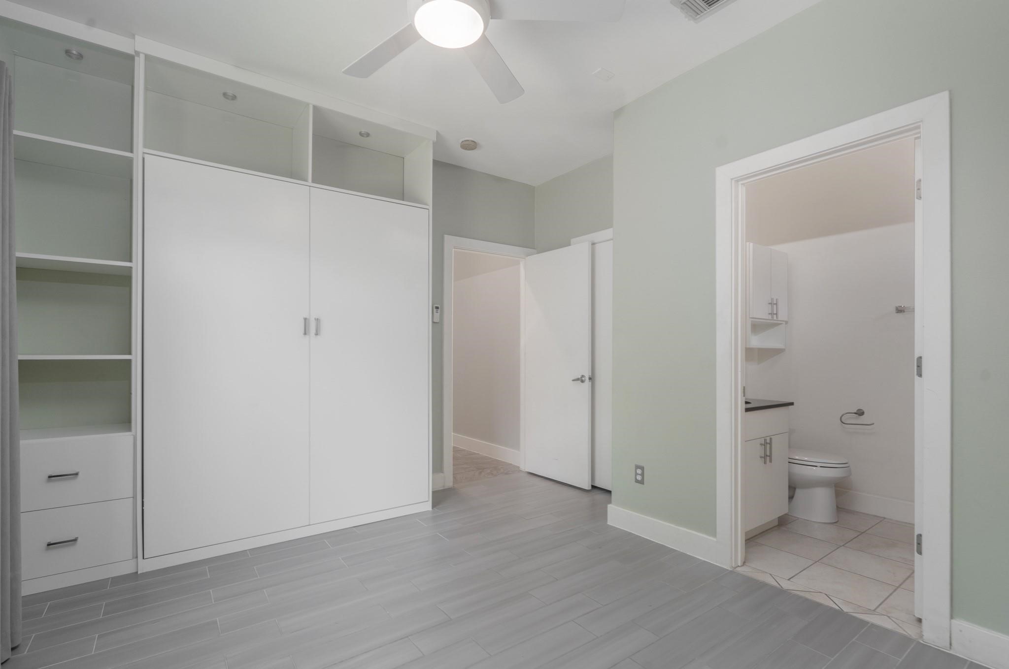 4302 Spencer Street Houston, TX 77007 - Photo 15 of 21 a view of a bathroom with a walk in closet and wooden floor
