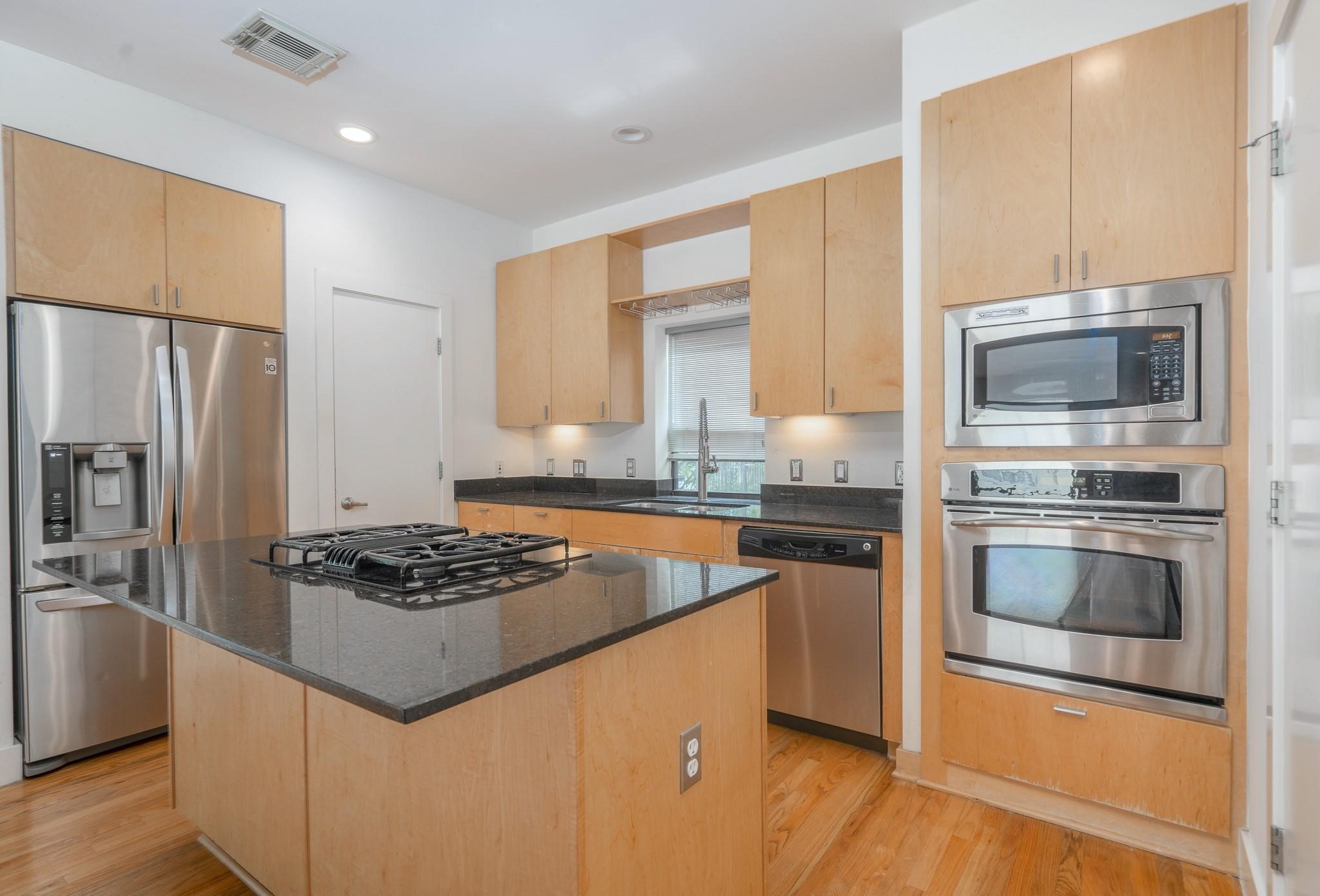 4302 Spencer Street Houston, TX 77007 - Photo 21 of 21 a kitchen with granite countertop stainless steel appliances and wooden cabinets