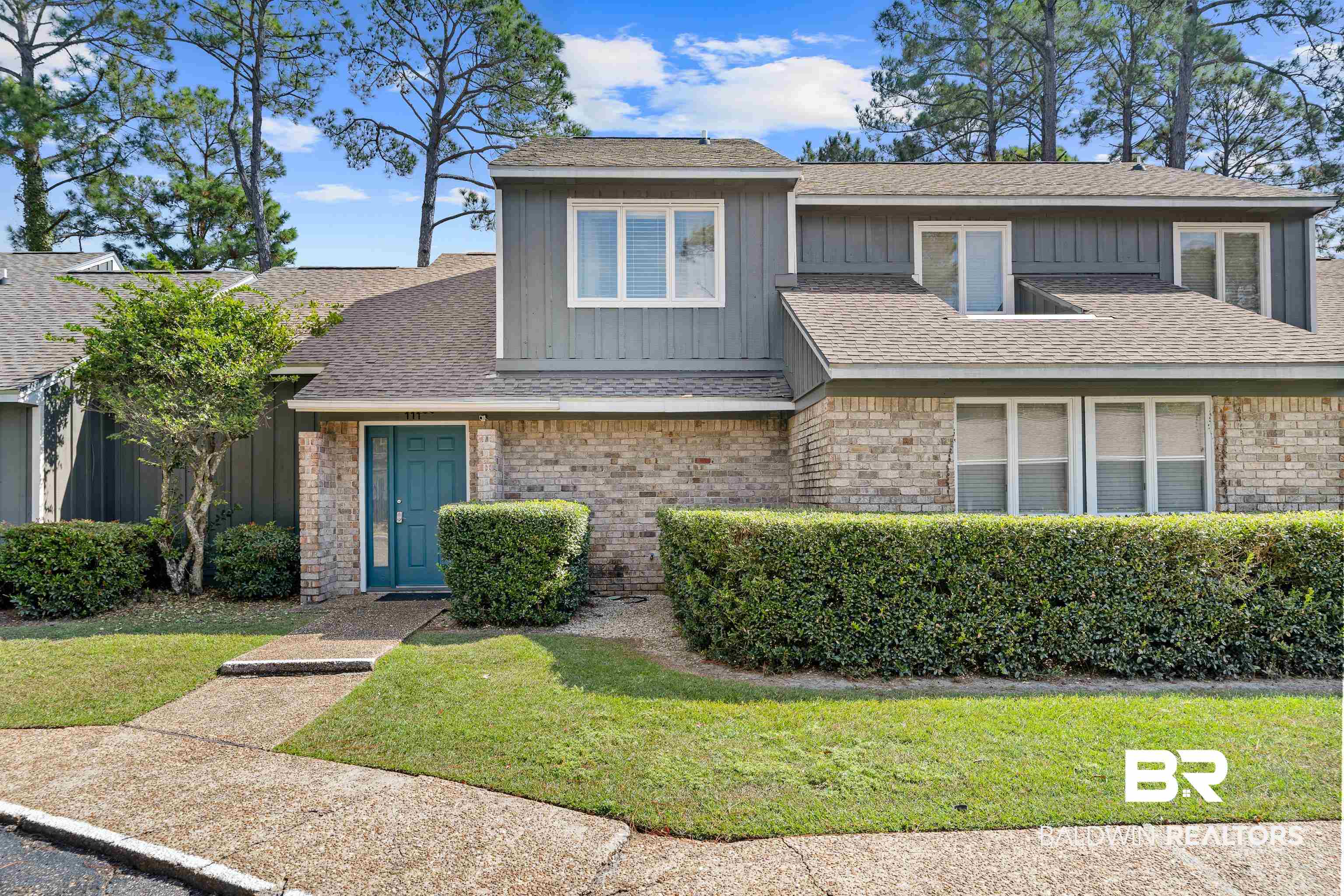 1701 Regency Road, Unit 111 Gulf Shores, AL 36542 - Photo 2 of 29 View of front of property featuring a front yard