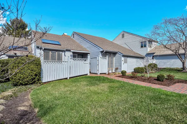 a view of a house with a yard and sitting area