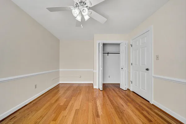a view of a room with wooden floor and closet area