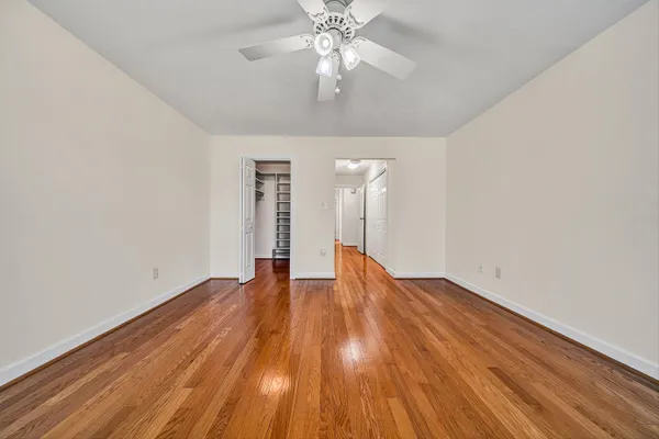 a view of walk in closet with empty racks