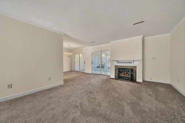 a view of an empty room with a fireplace