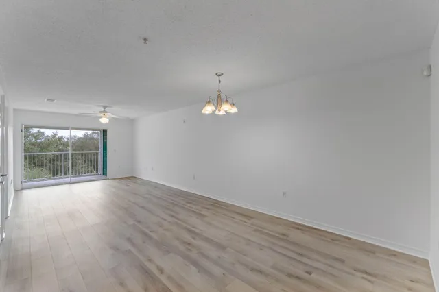 a view of a room with wooden floor and a window