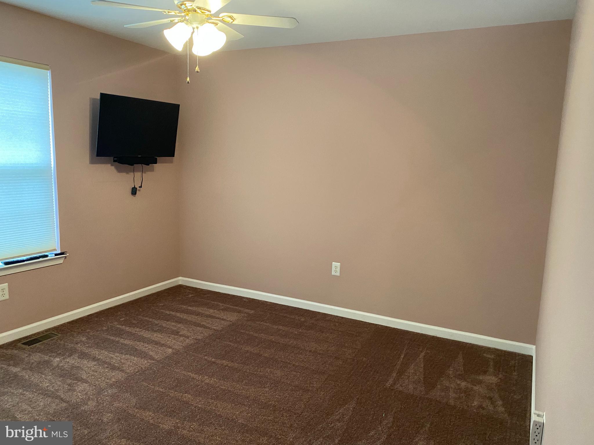14 Mailly Drive Townsend, DE 19734 - Photo 16 of 22 en empty room with wooden floor and flat screen tv