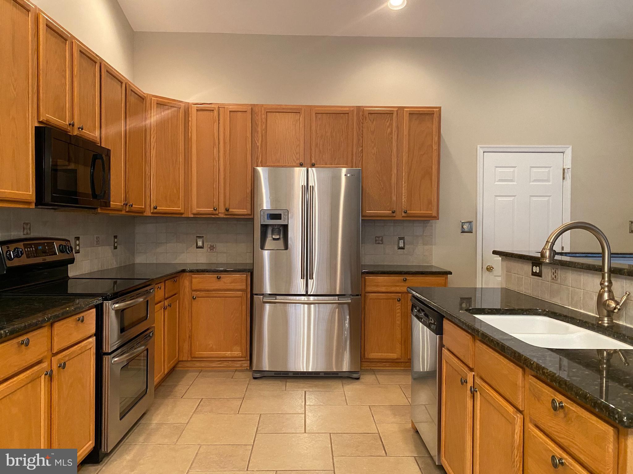 14 Mailly Drive Townsend, DE 19734 - Photo 7 of 22 a kitchen with stainless steel appliances granite countertop a refrigerator sink and stove