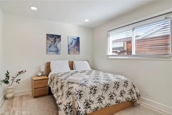 a bed sitting in a bedroom next to a window