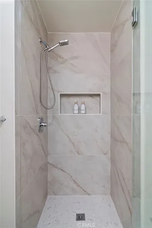 a bedroom with a bed and a table in it with window