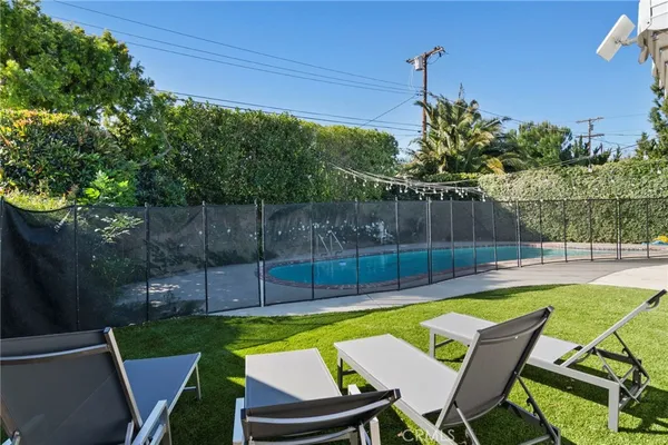 a view of a backyard with swimming pool