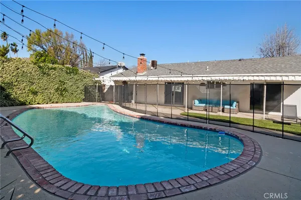 a view of a swimming pool with a yard