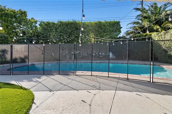 a view of a patio with table and chairs potted plants with wooden floor and fence