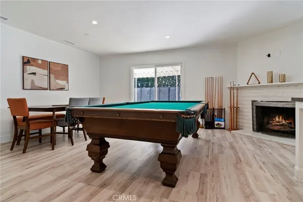a room with furniture pool table and a fireplace