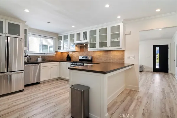 a kitchen with granite countertop a sink and cabinets