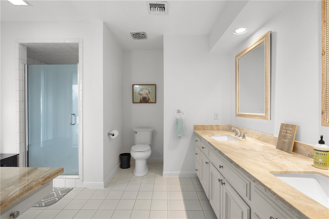 871 Cazey Loop Franklin, TX 77856 - Photo 25 of 42 a spacious bathroom with a granite countertop sink and a mirror
