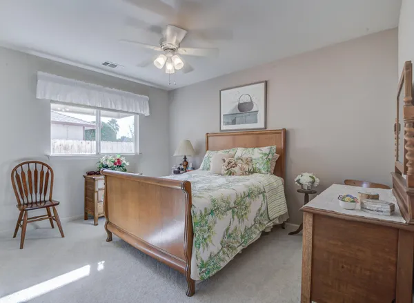 a bedroom with a bed and a chair