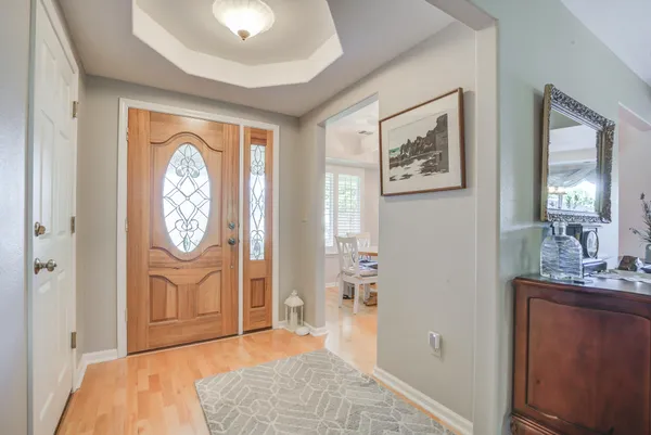 a view of an entryway with wooden floor