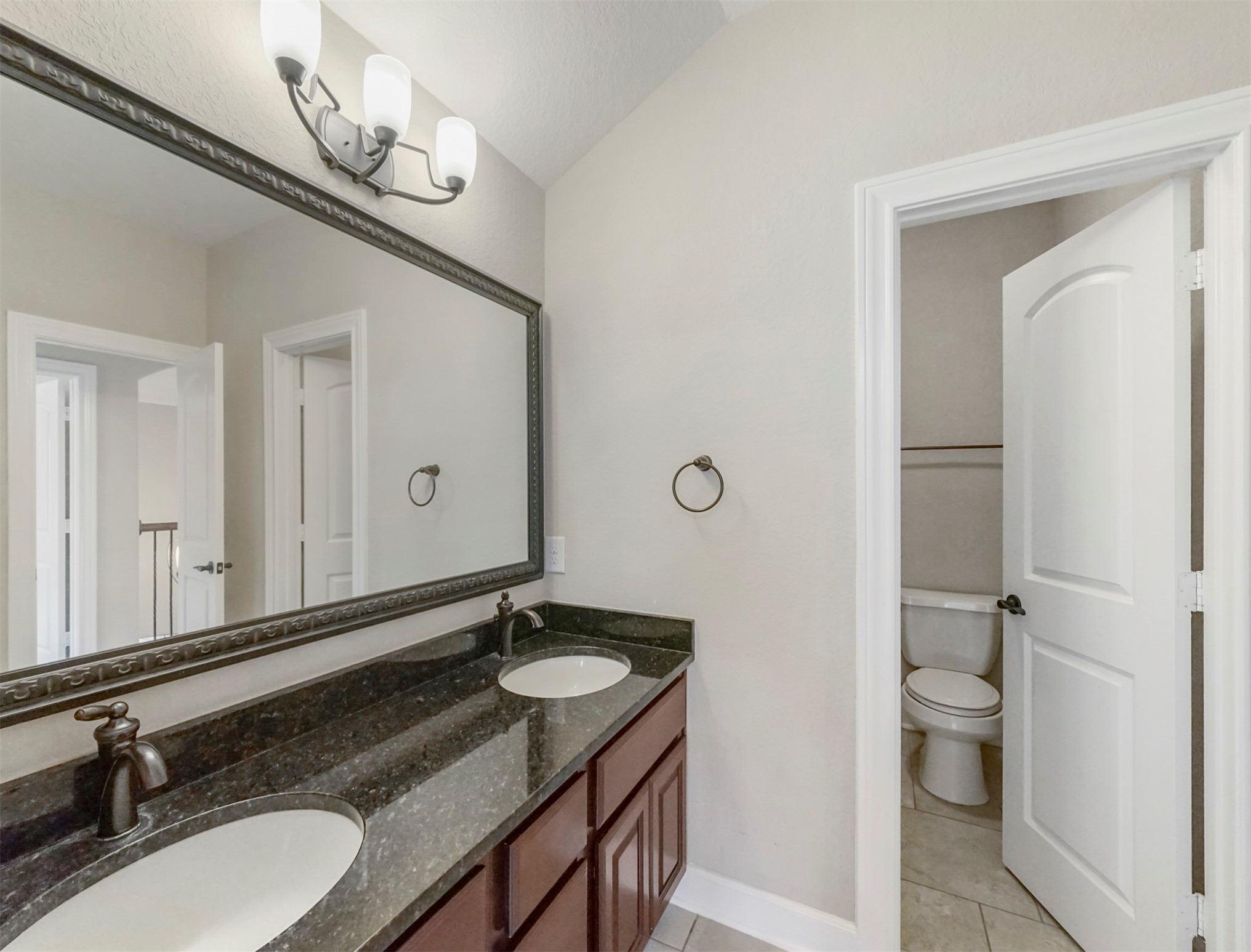 9915 Rochs Hill Court Katy, TX 77494 - Photo 20 of 32 a bathroom with a granite countertop sink and a mirror
